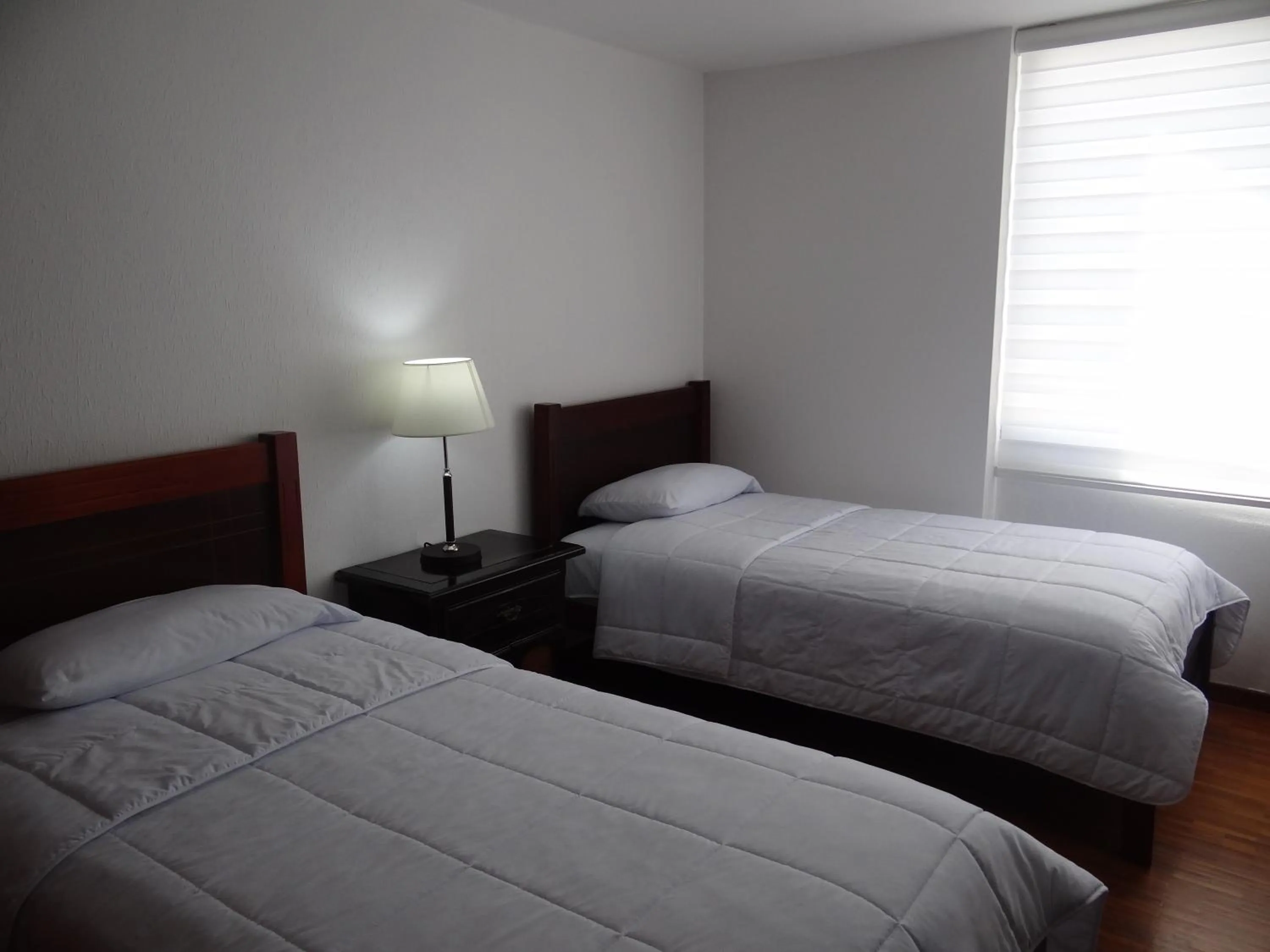 Bed in Altura Rooms & Suites