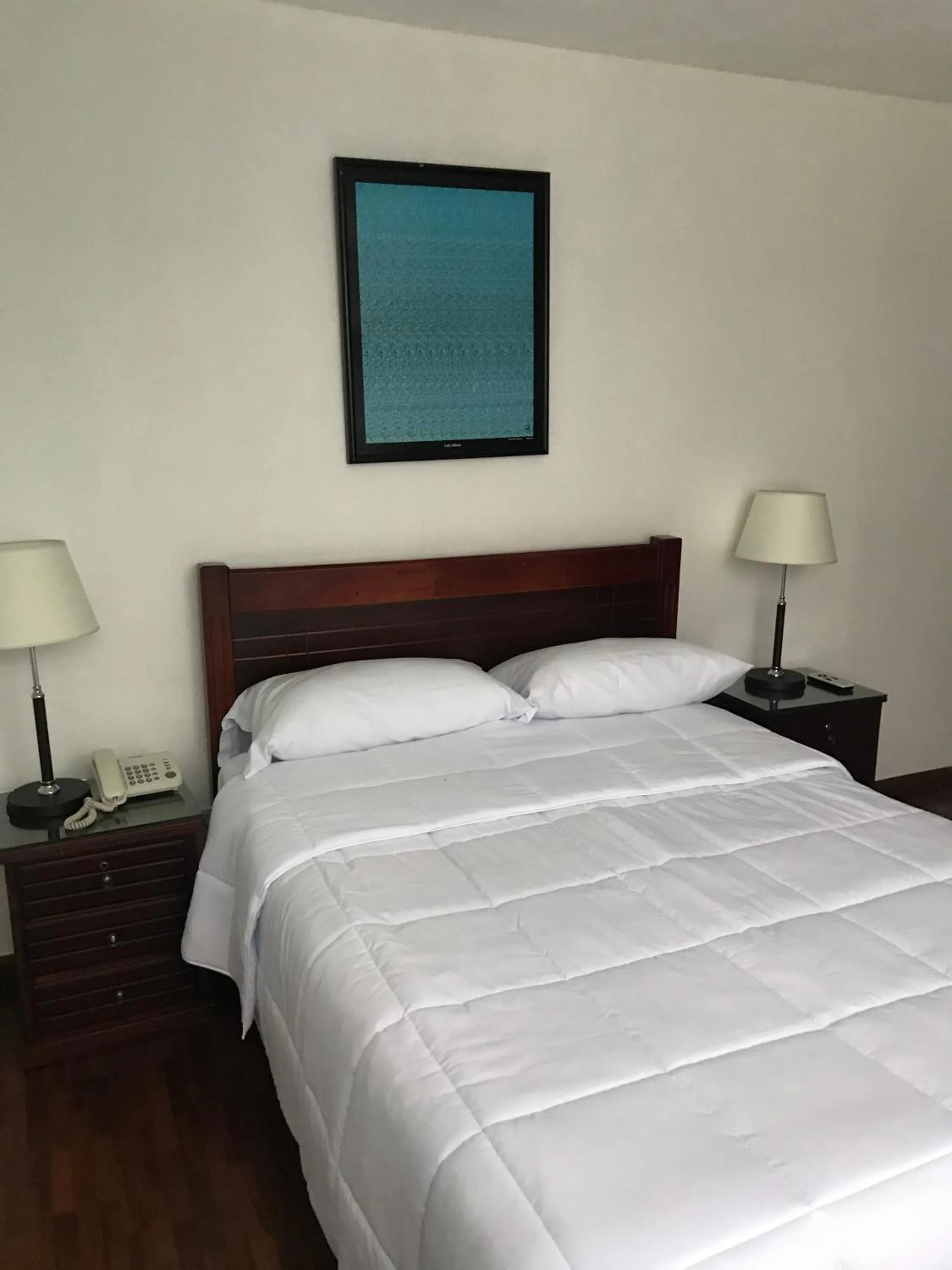 Bed in Altura Rooms & Suites
