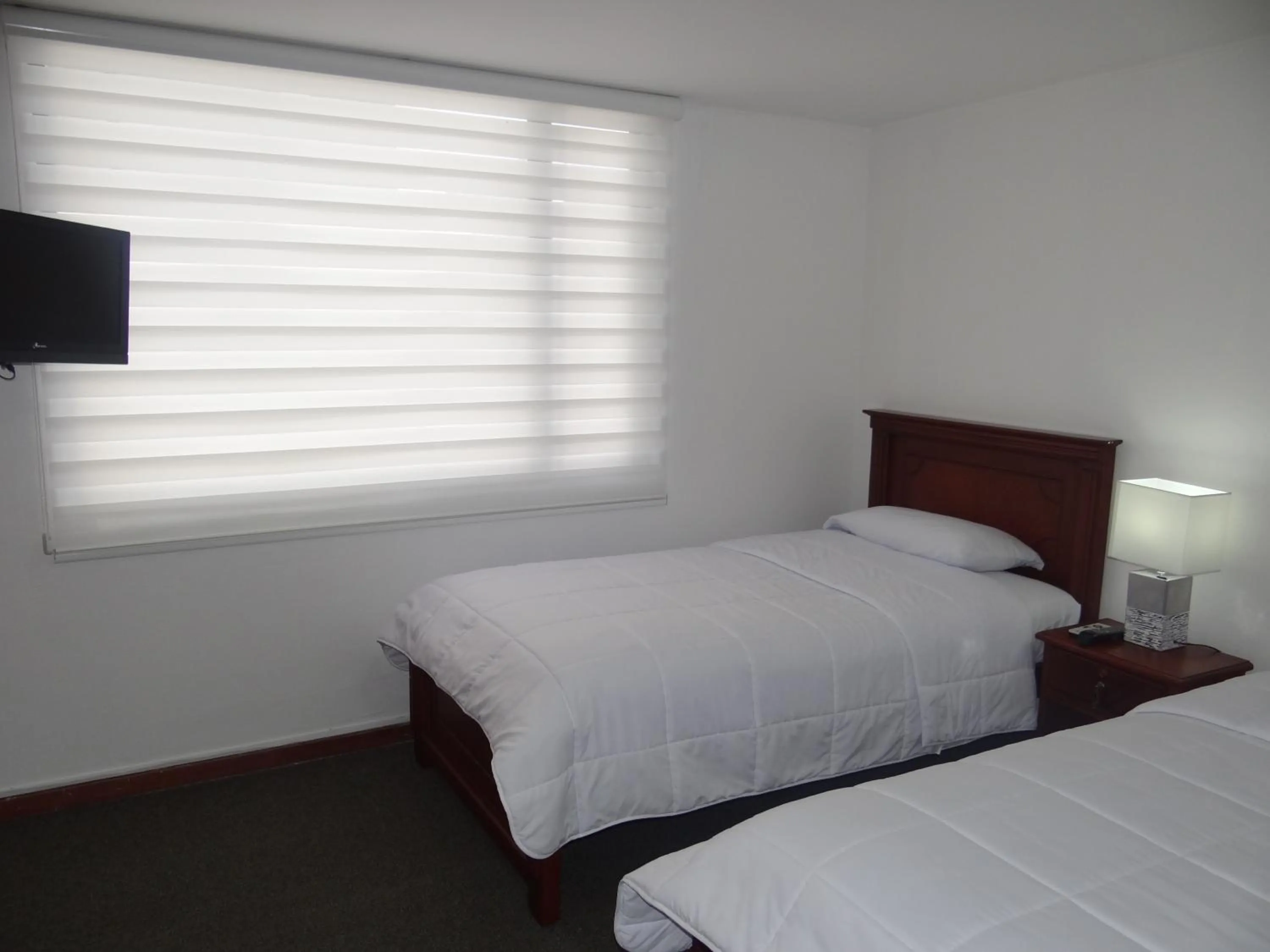 Bed in Altura Rooms & Suites