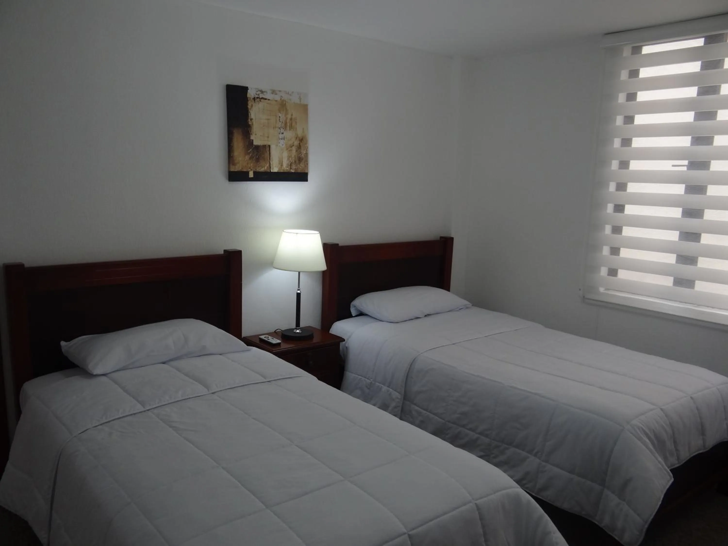 Bed in Altura Rooms & Suites