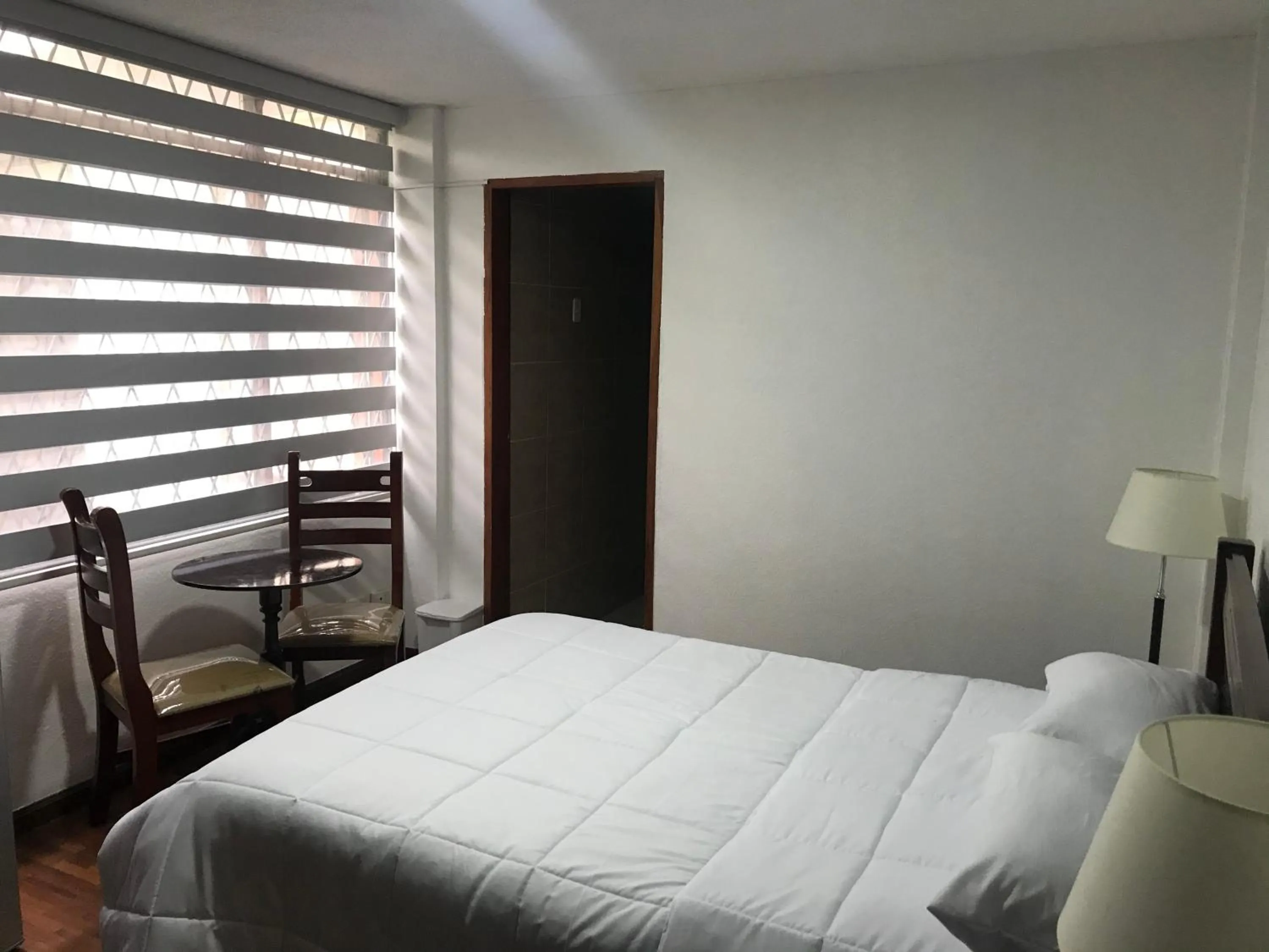 Bed in Altura Rooms & Suites