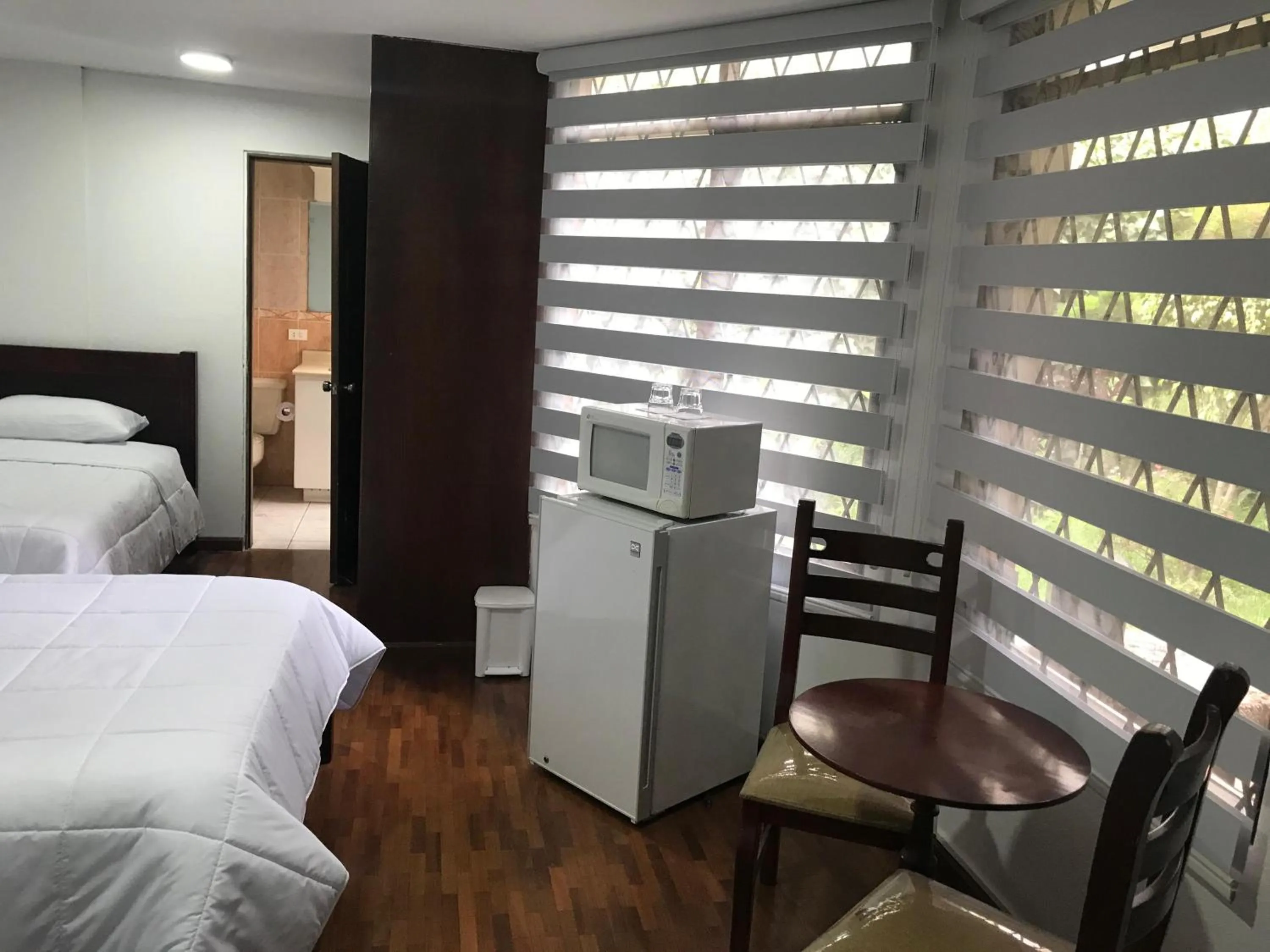 Bed in Altura Rooms & Suites