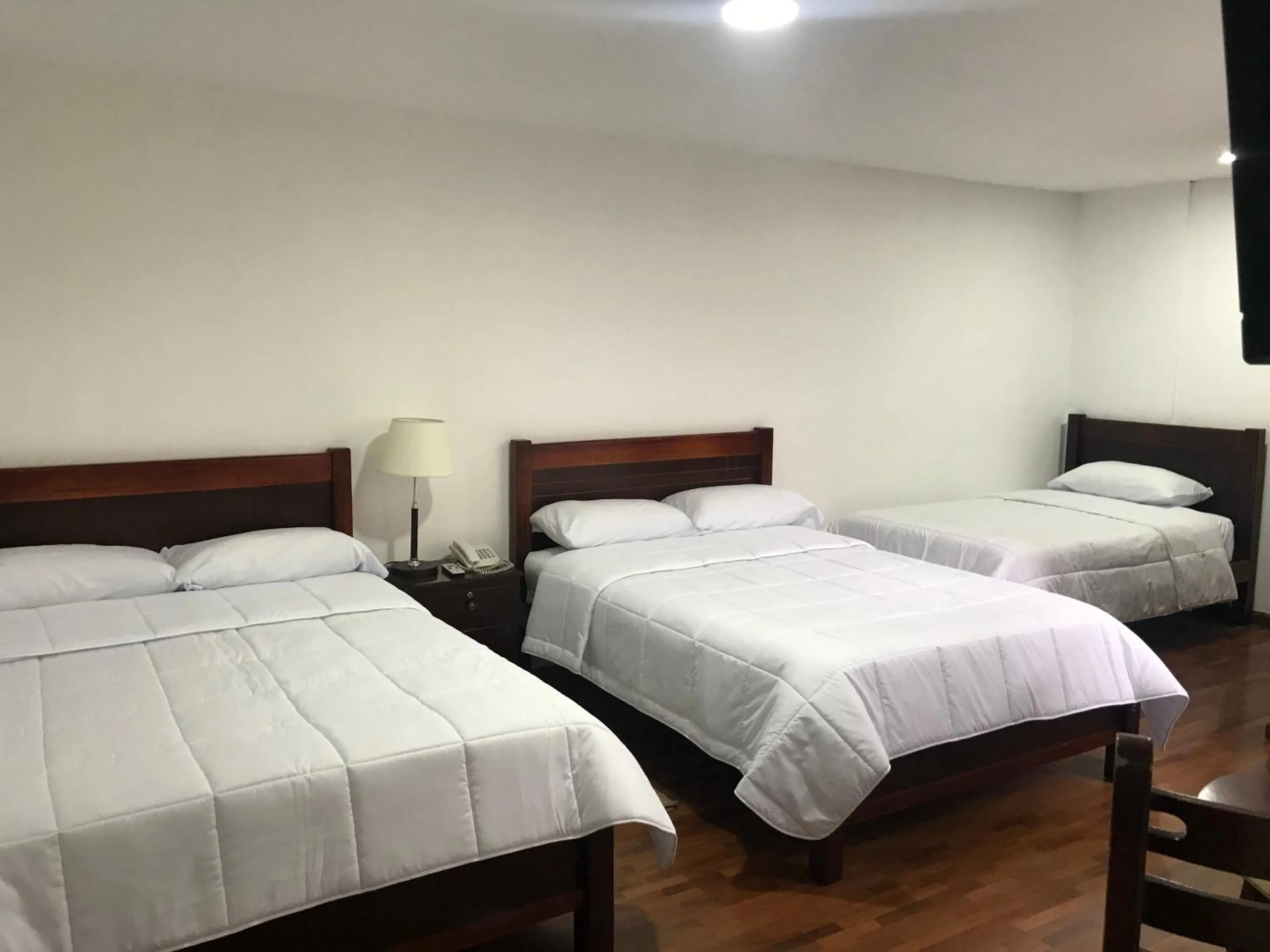 Bed in Altura Rooms & Suites