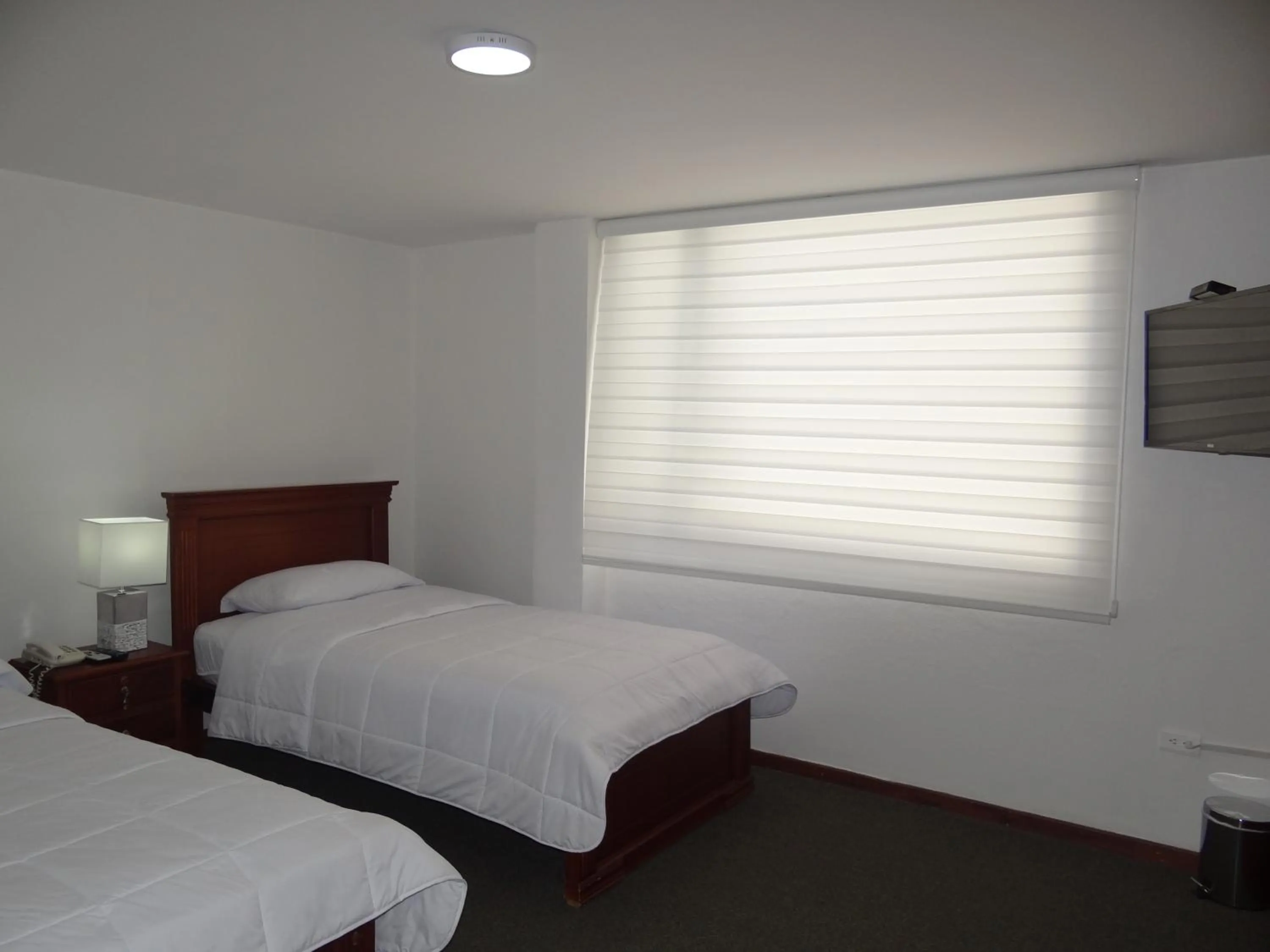 Bed in Altura Rooms & Suites