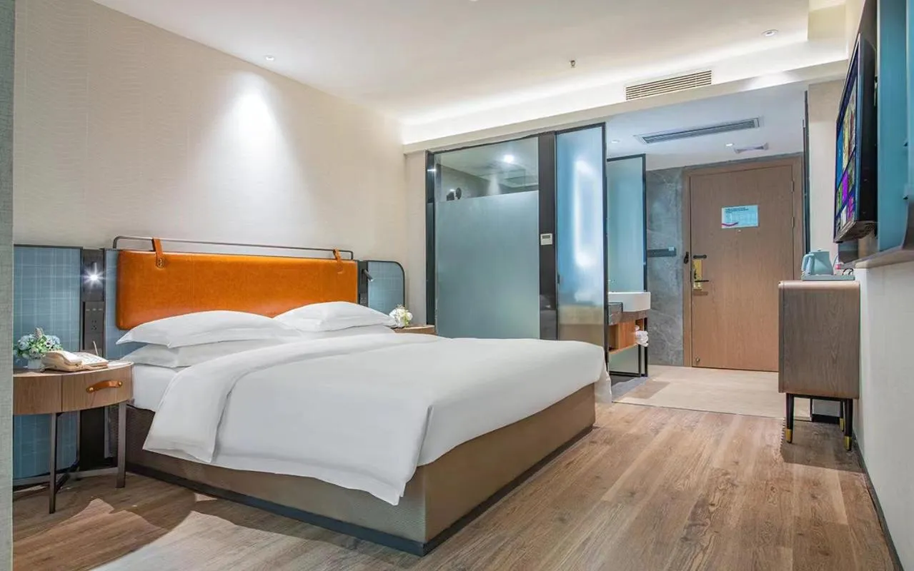 Bed in Echarm Hotel Guangzhou Jiahe Helong Branch