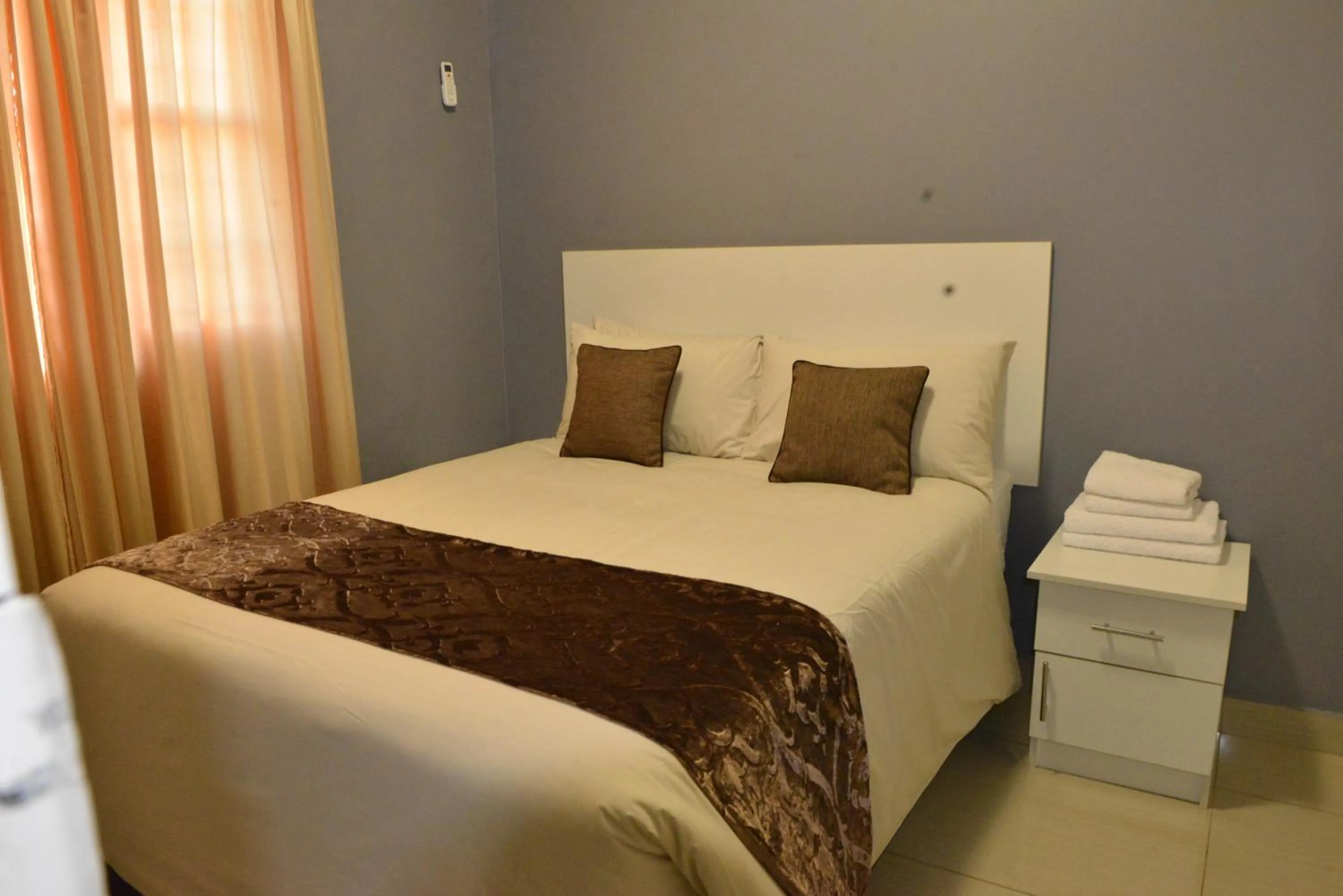 Bed in Asante Apartments