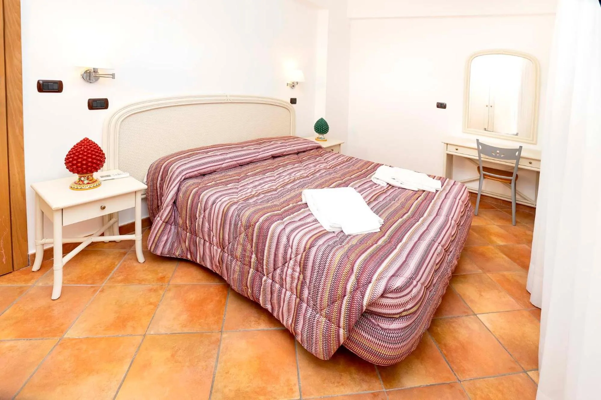 Bed in Le Tartarughe Aparthotel