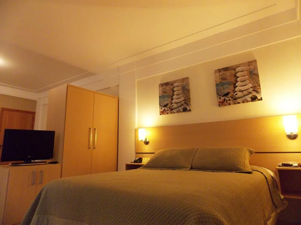Communal lounge/ TV room, Bed in Itajubá Flat Hotel