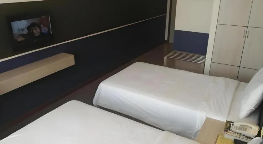 Bed in Grand Medallion Hotel