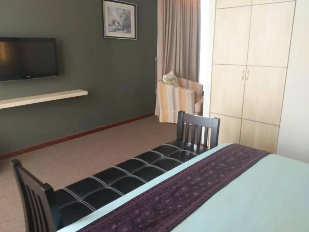 Bed in Grand Medallion Hotel