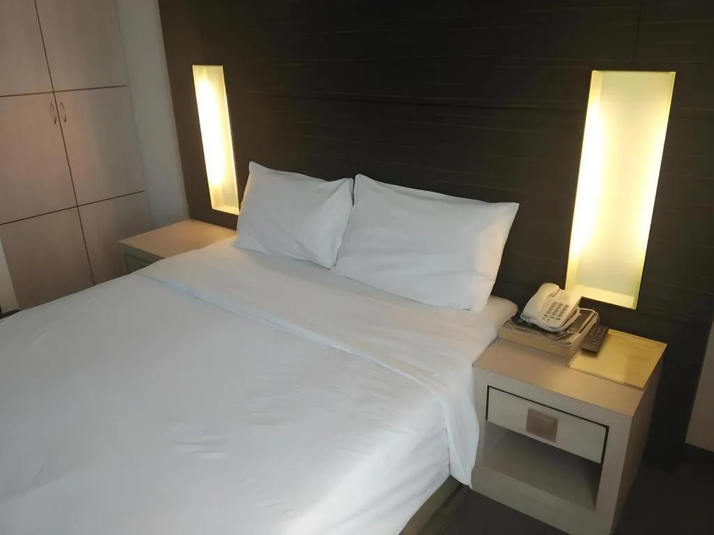 Bed in Grand Medallion Hotel