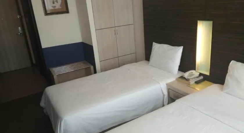 Bed in Grand Medallion Hotel