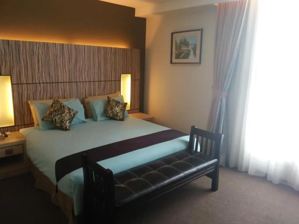 Bed in Grand Medallion Hotel