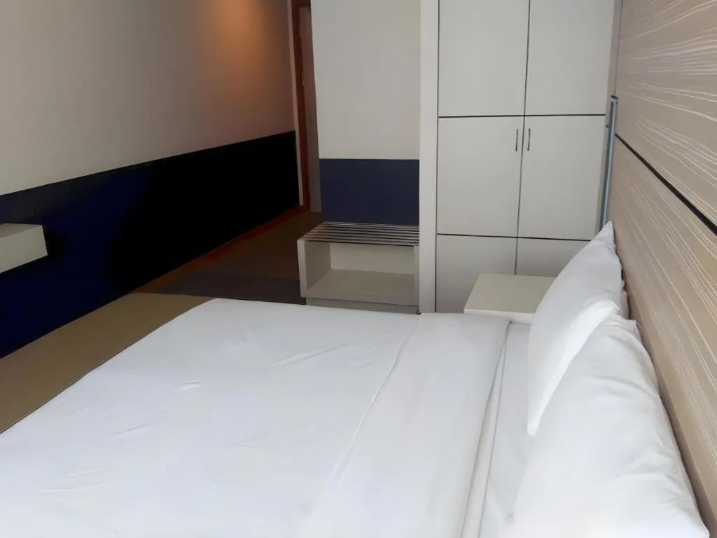 Bed in Grand Medallion Hotel