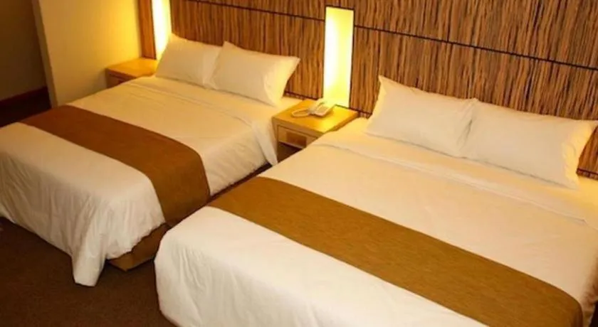 Bed in Grand Medallion Hotel