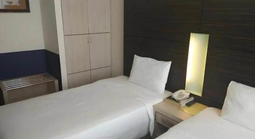 Bed in Grand Medallion Hotel