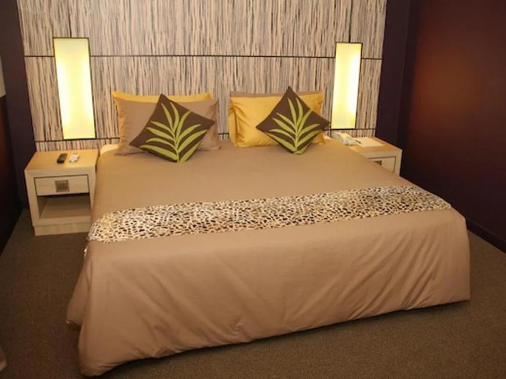 Bed in Grand Medallion Hotel