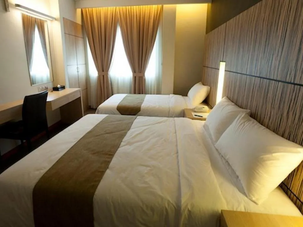 Bed in Grand Medallion Hotel