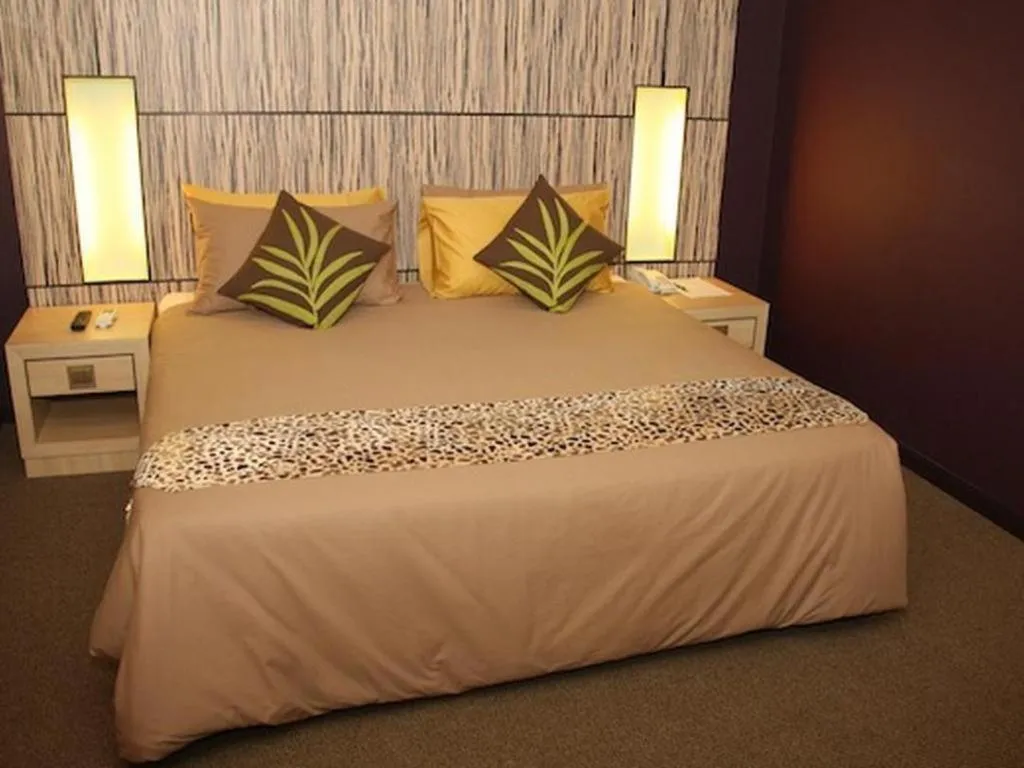 Bed in Grand Medallion Hotel