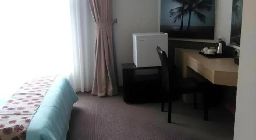 Bed in Grand Medallion Hotel