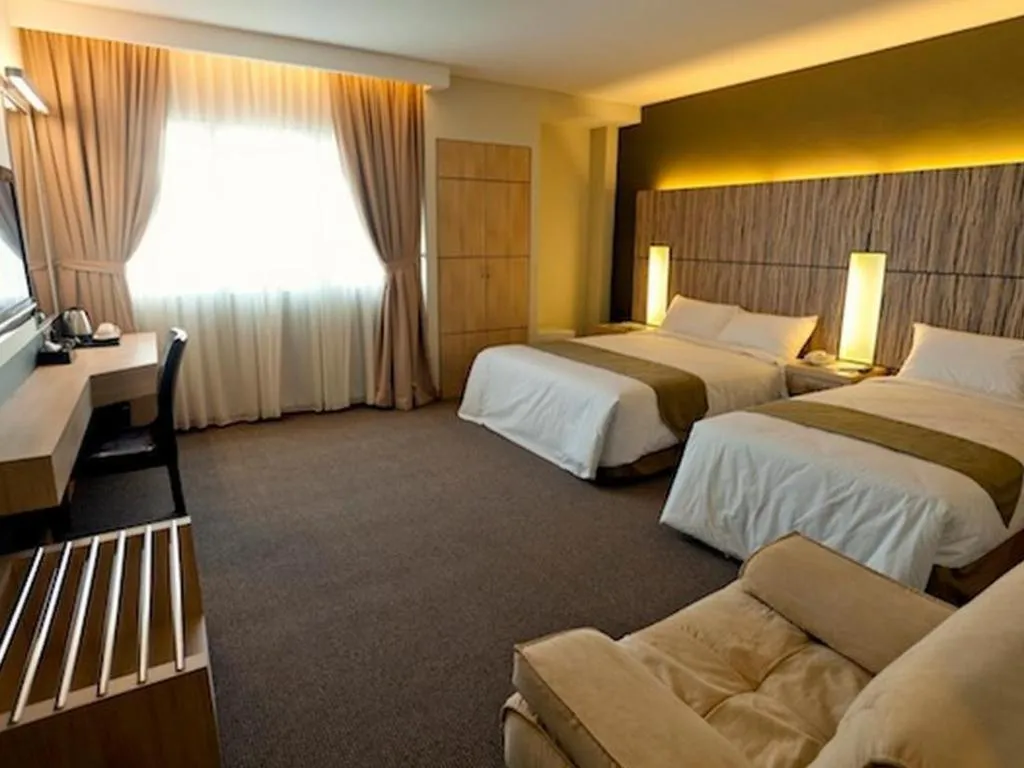 Bed in Grand Medallion Hotel