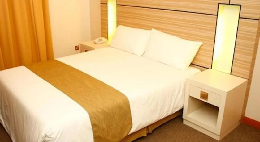 Bed in Grand Medallion Hotel