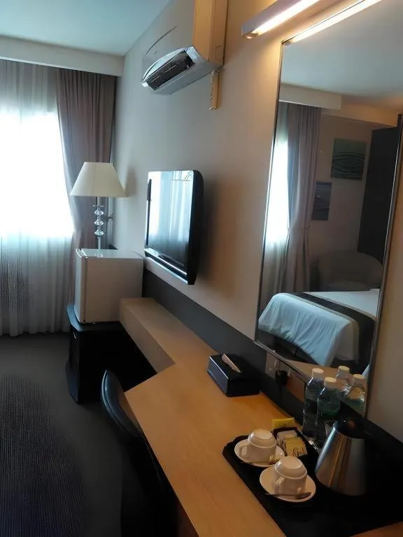 Bed in Grand Medallion Hotel