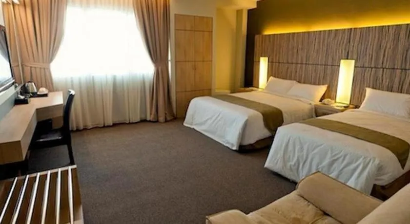 Bed in Grand Medallion Hotel