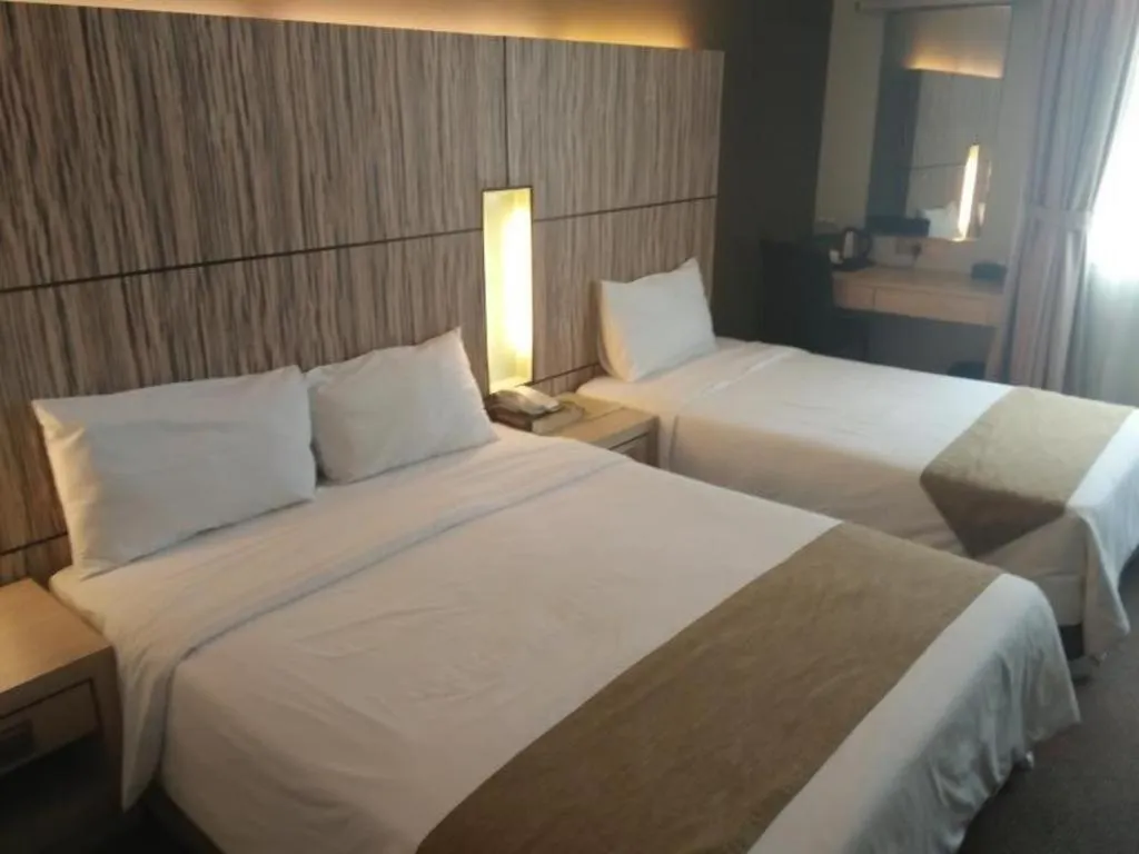 Bed in Grand Medallion Hotel