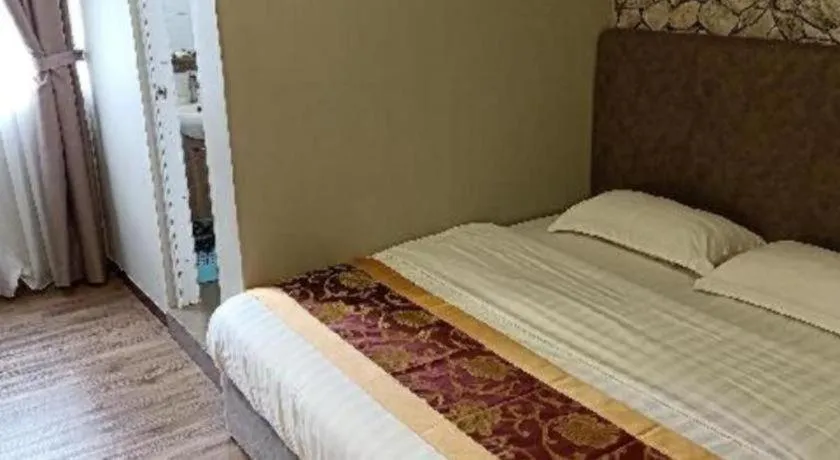 Bed in M GLOBAL HOTEL