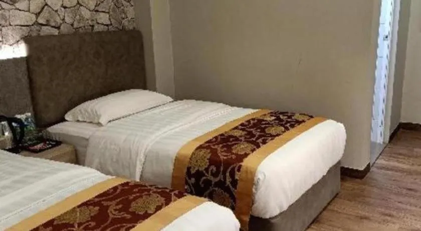 Bed in M GLOBAL HOTEL