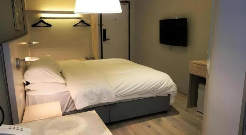 Bed in M Plus Boutique Hotel