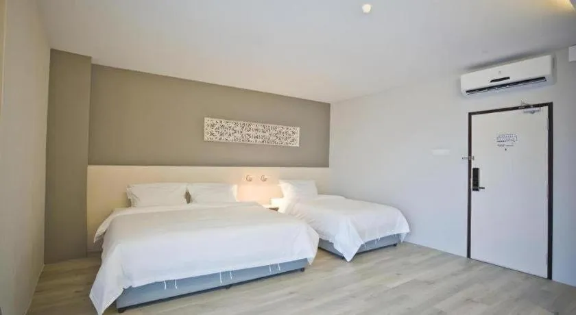 Bed in M Plus Boutique Hotel