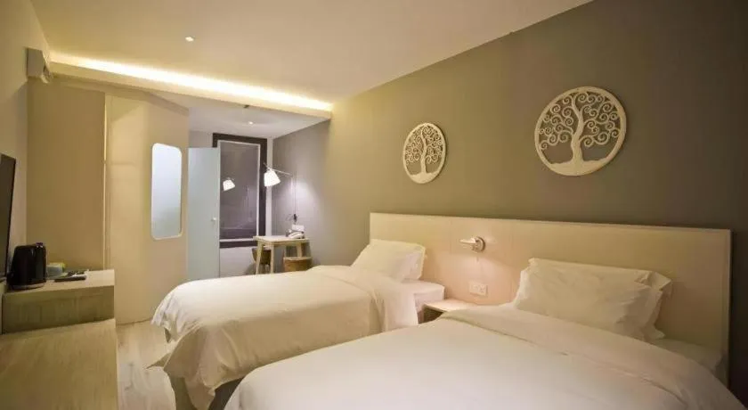 Bed in M Plus Boutique Hotel