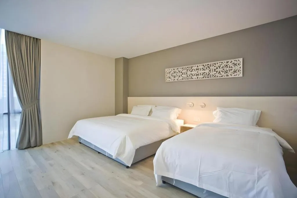 Bed in M Plus Boutique Hotel