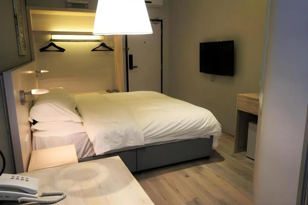 Bed in M Plus Boutique Hotel