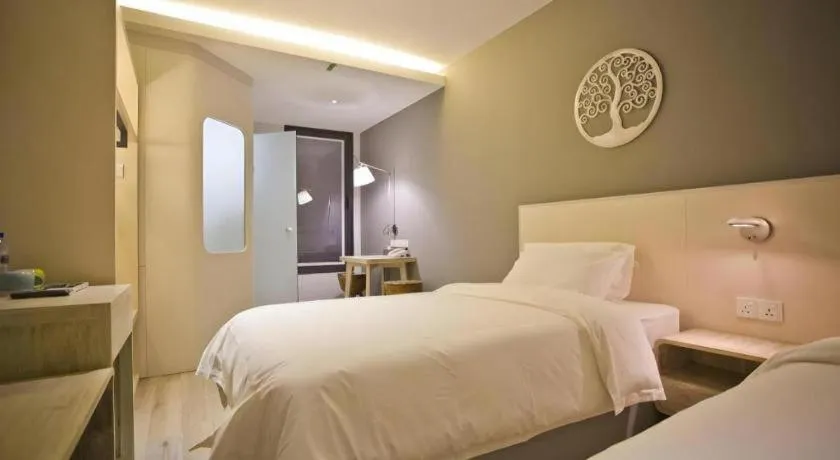 Bed in M Plus Boutique Hotel