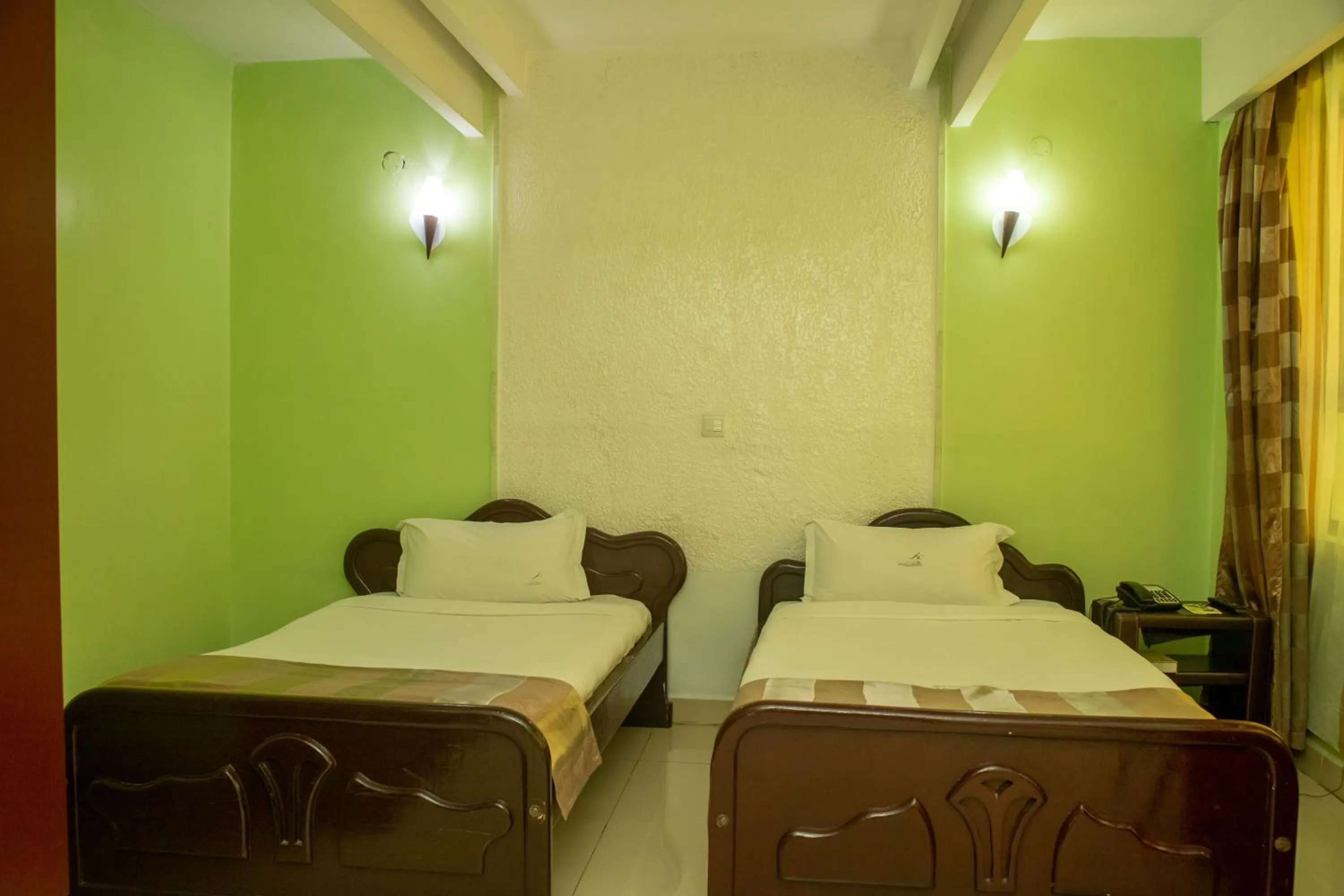 Bed in Legacy Hotel and Conference Centre ltd