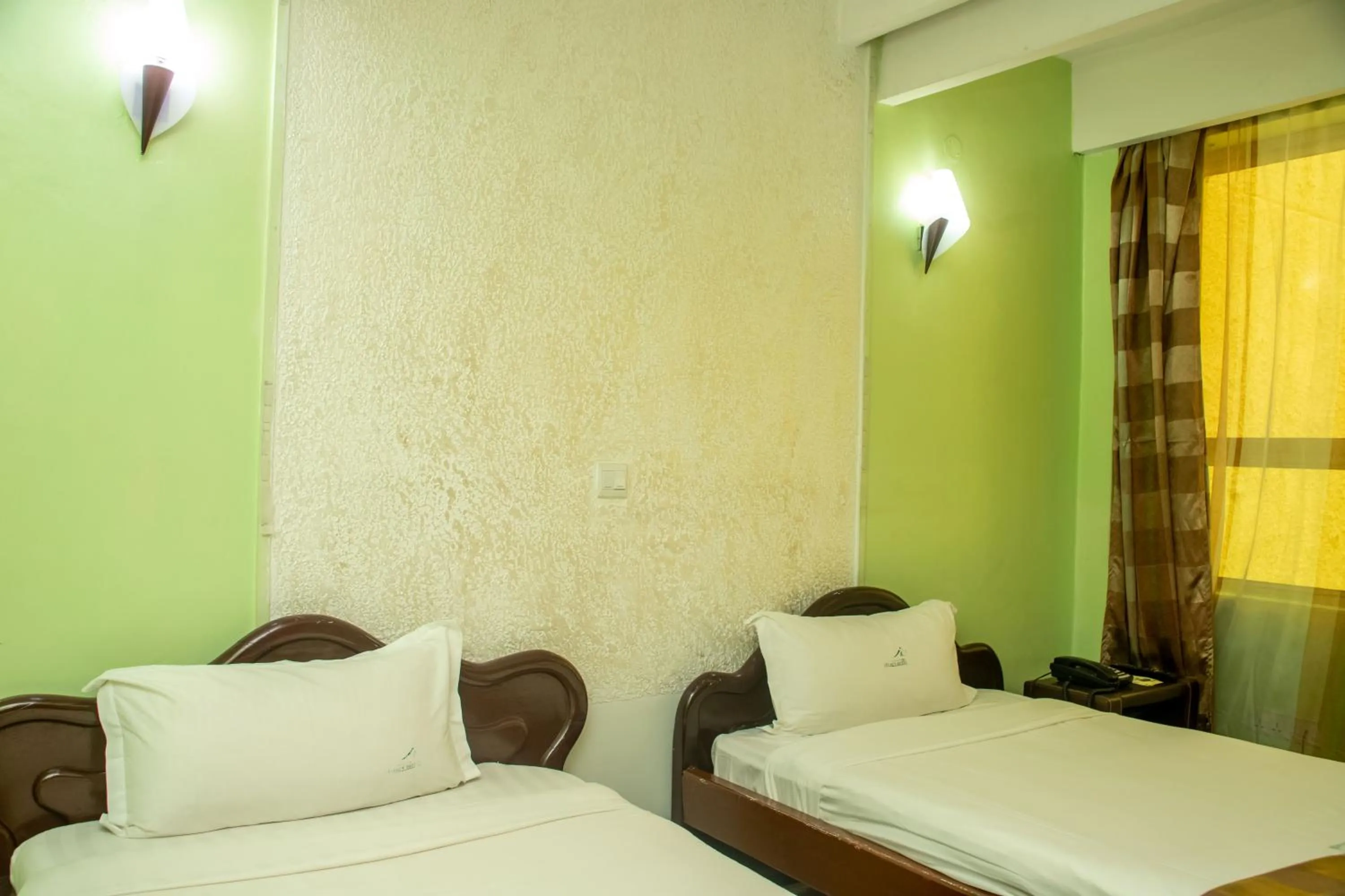 Bed in Legacy Hotel and Conference Centre ltd