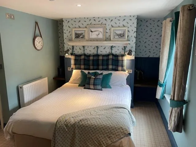 Bed in The Golden Pheasant Inn