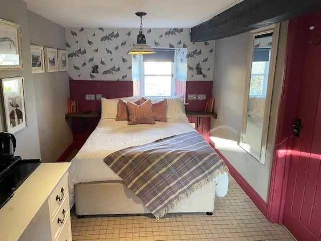 Bed in The Golden Pheasant Inn