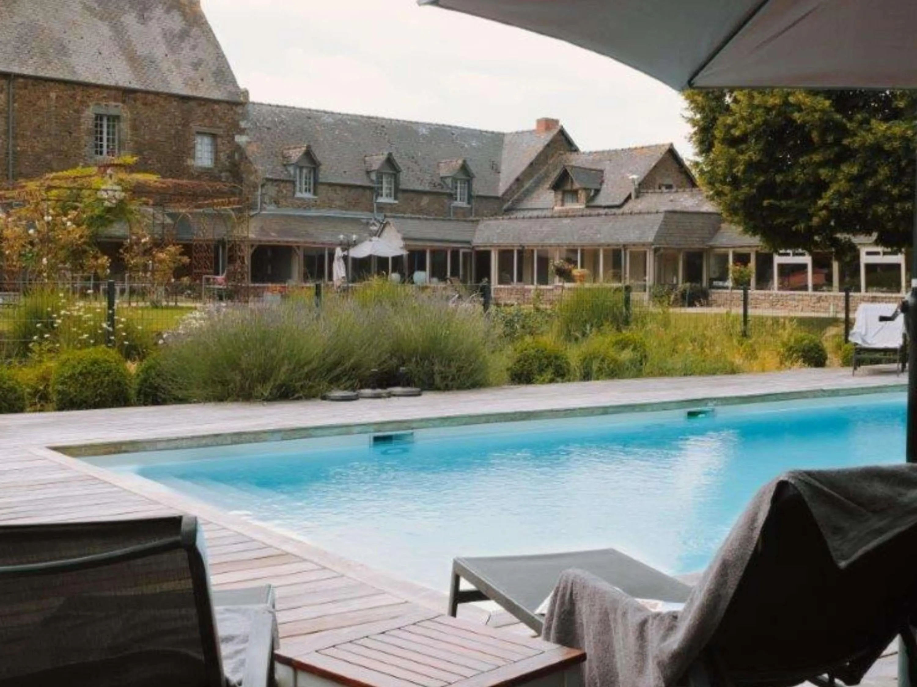 Pool view in Hotel de L'Abbaye Le Tronchet - Handwritten Collection