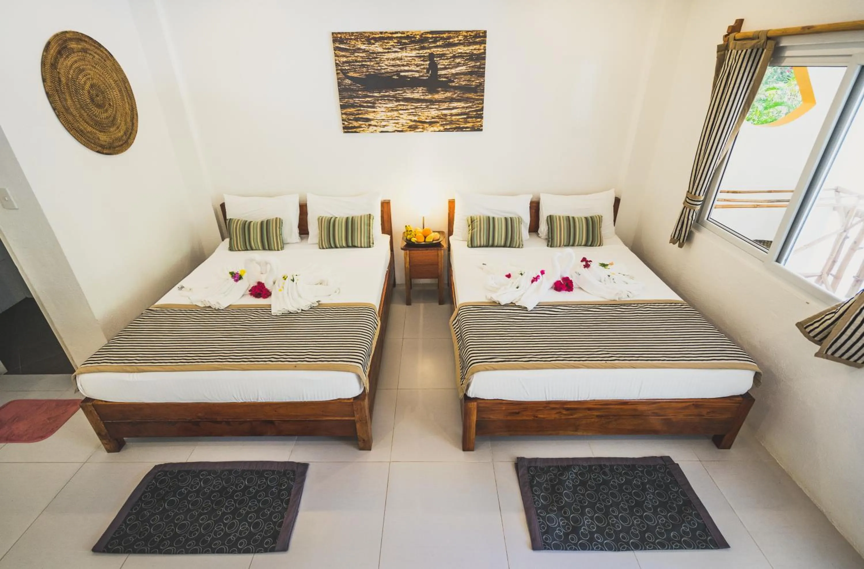 Photo of the whole room, Bed in Evolution Dive and Beach Resort