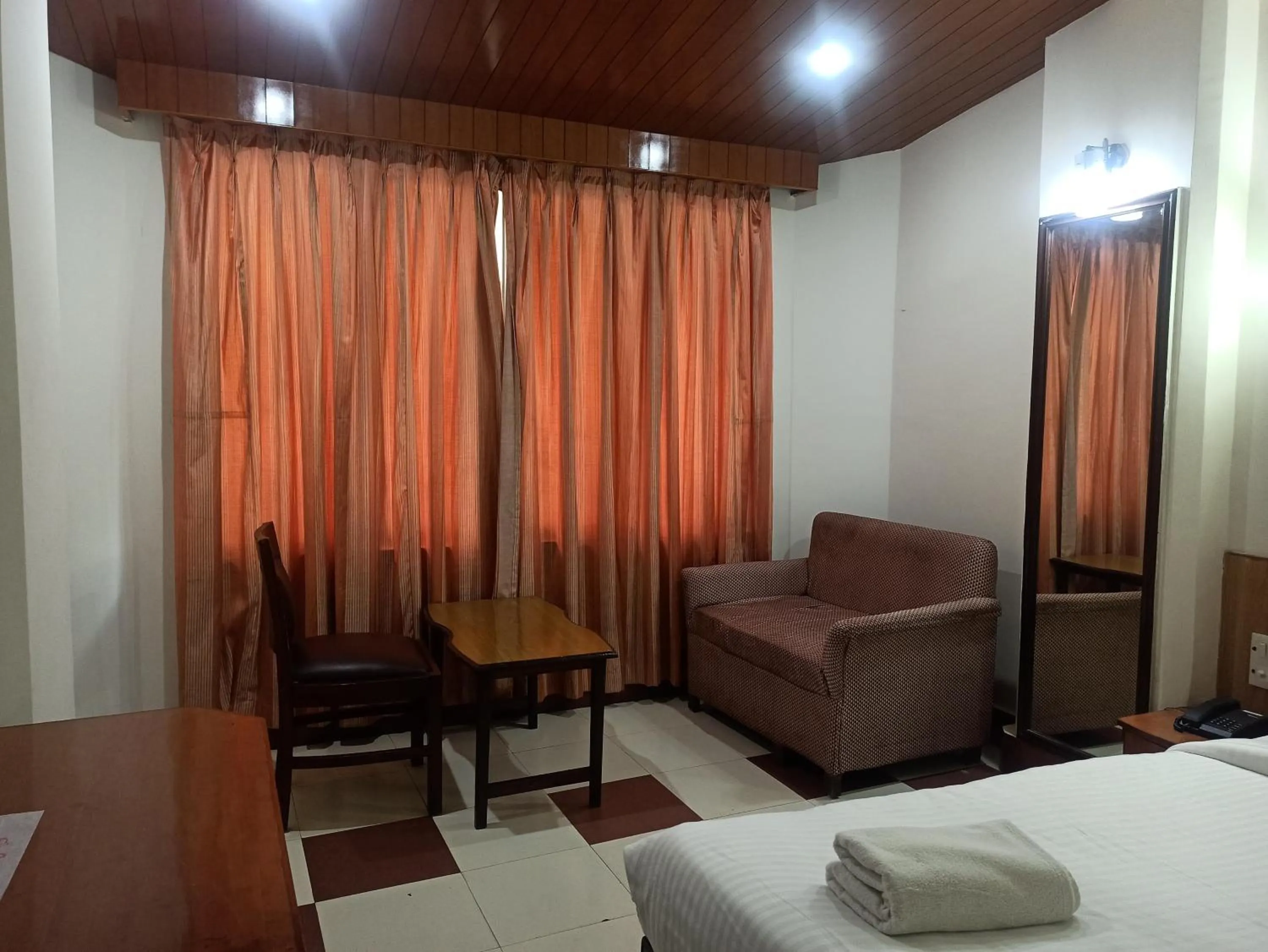 Bedroom in Hotel Ambarish Grand Residency
