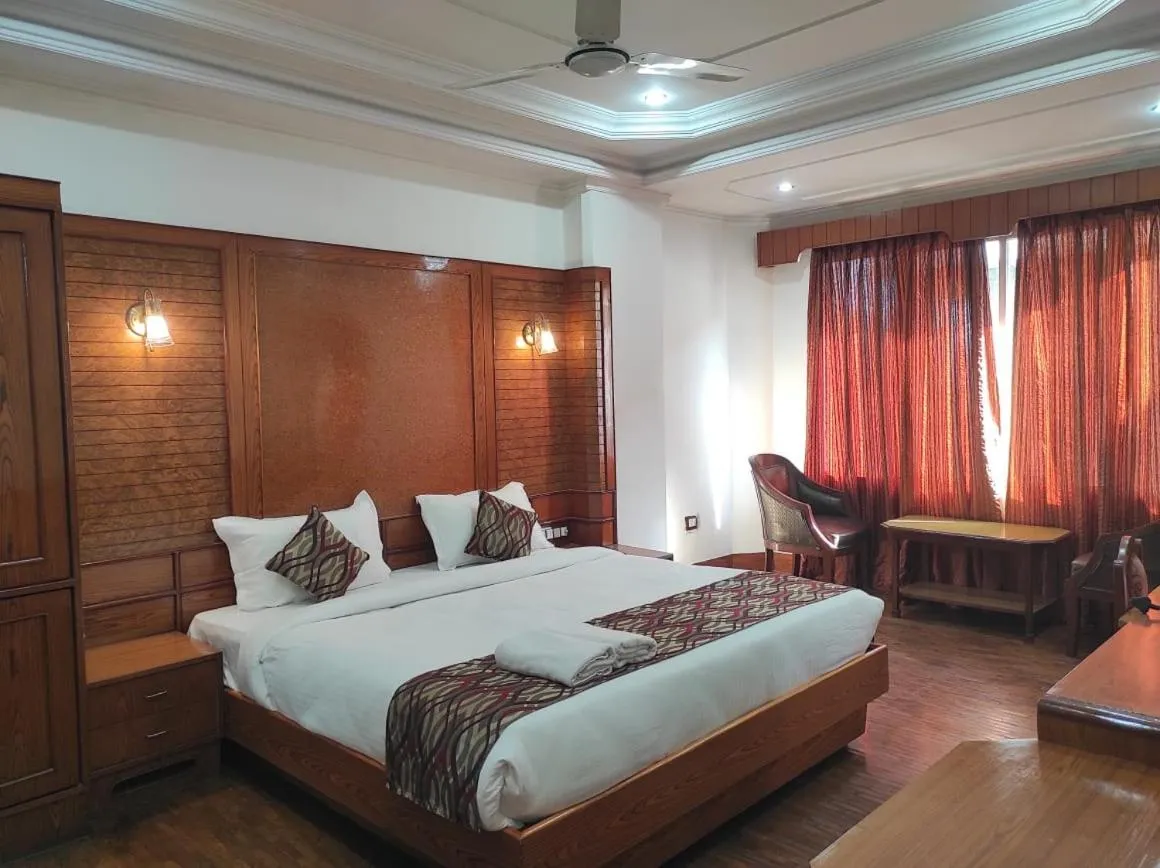 Bedroom in Hotel Ambarish Grand Residency