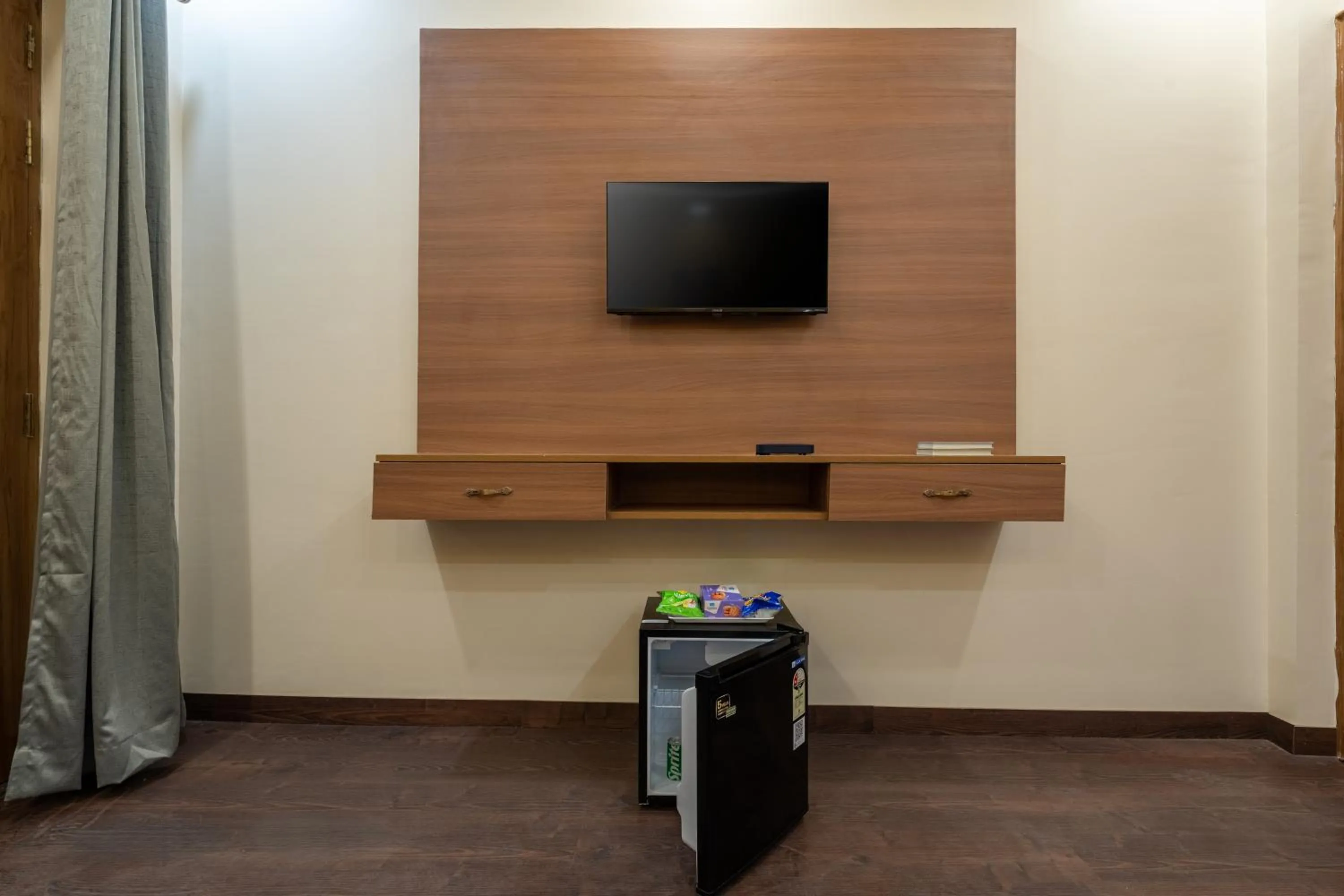 TV and multimedia in Lime Tree Hotel & One Bed Room Serviced Apartment Nearby Noida Sector 50 Metro & Medanta Hospital with Party Venue