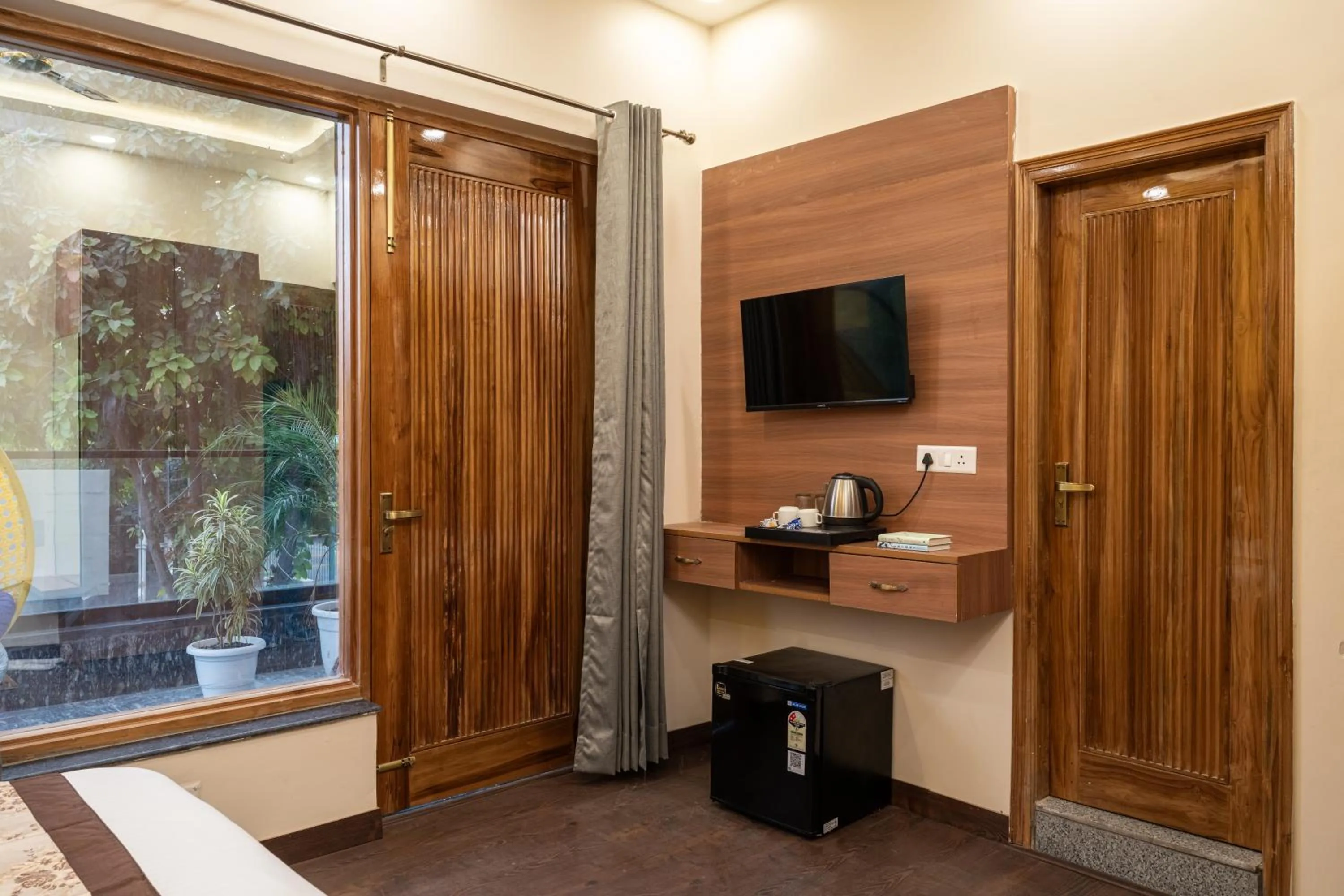 TV and multimedia in Lime Tree Hotel & One Bed Room Serviced Apartment Nearby Noida Sector 50 Metro & Medanta Hospital with Party Venue