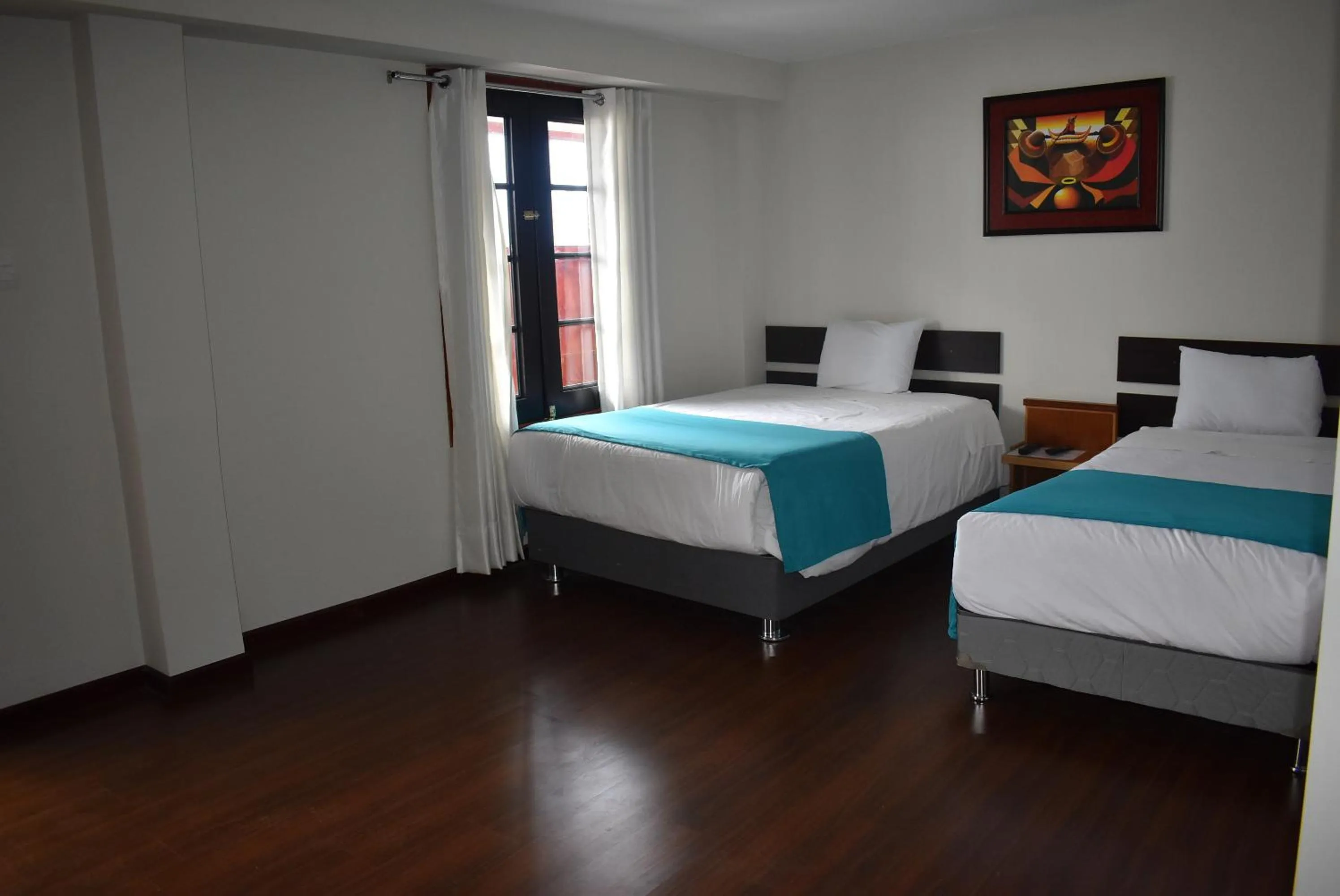 Bed in Colonial Plaza Hotel