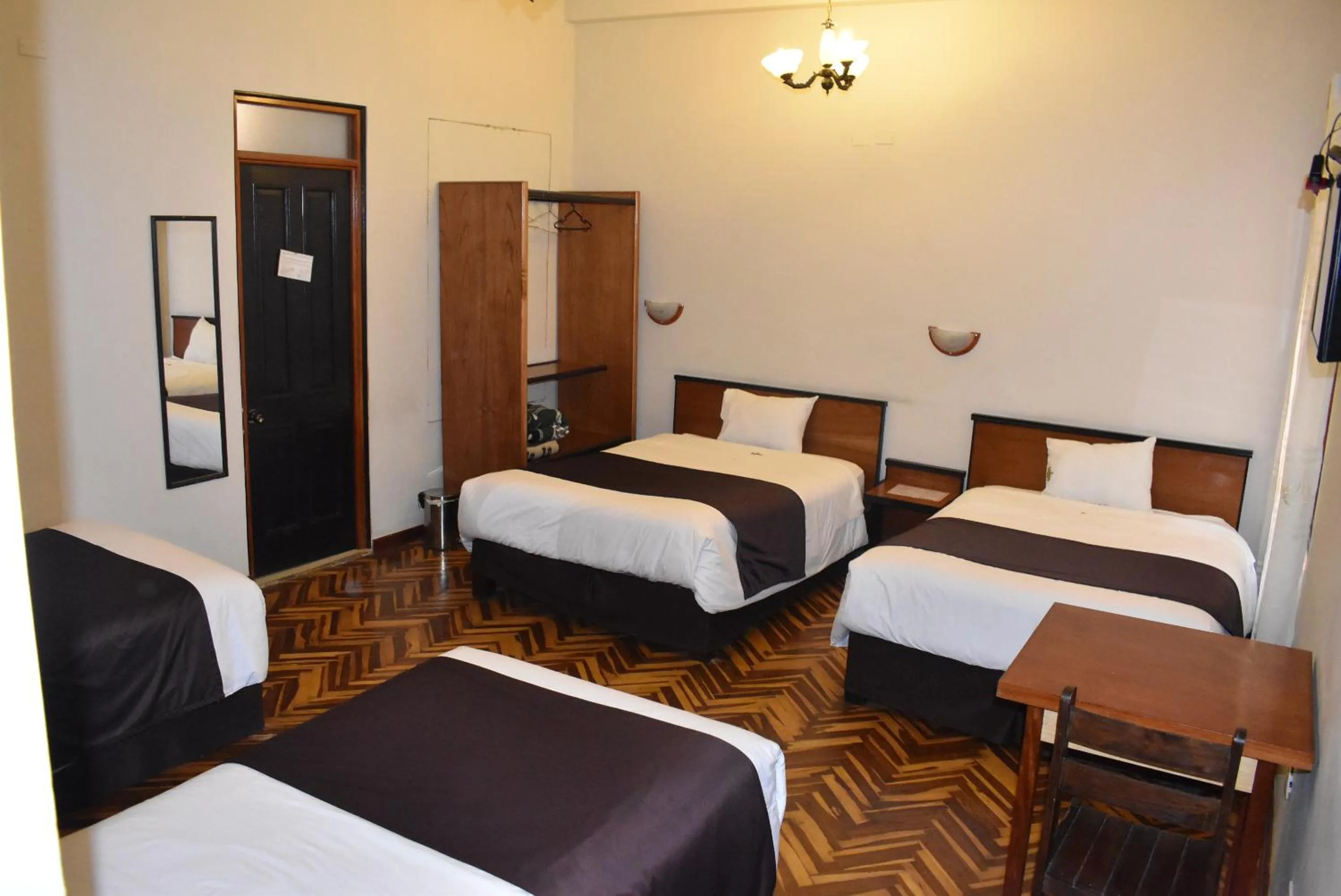 Bed in Colonial Plaza Hotel