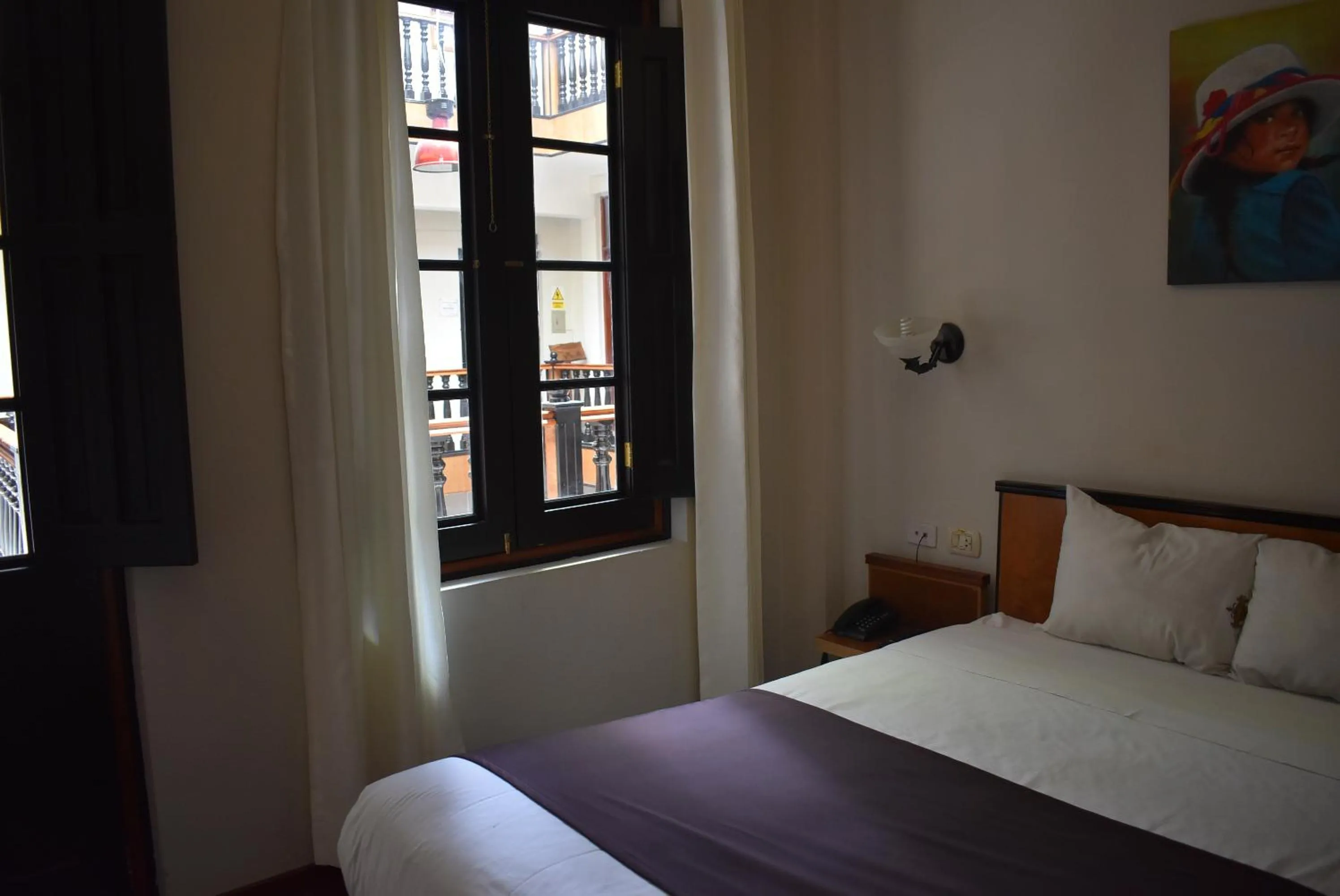 Bed in Colonial Plaza Hotel